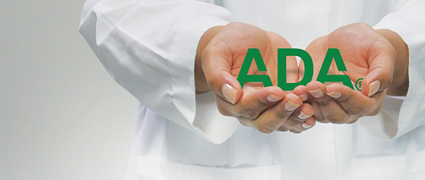 ADA logo in held by two hands by a person in a lab coat